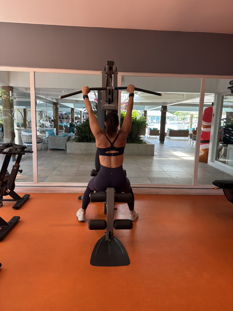 A woman using a cable pulldown machine